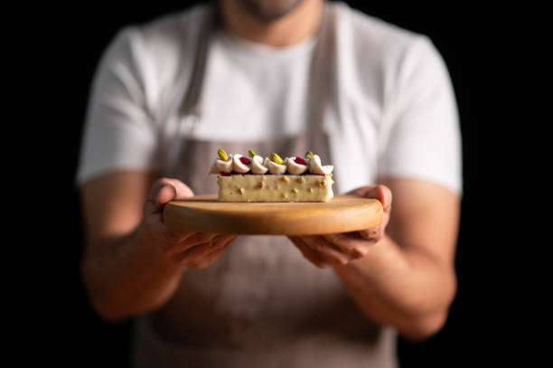 istock A male pastry chef holding a cake 2165399314