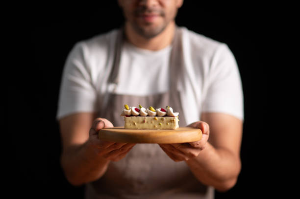 istock A male pastry chef holding a cake 2165399362