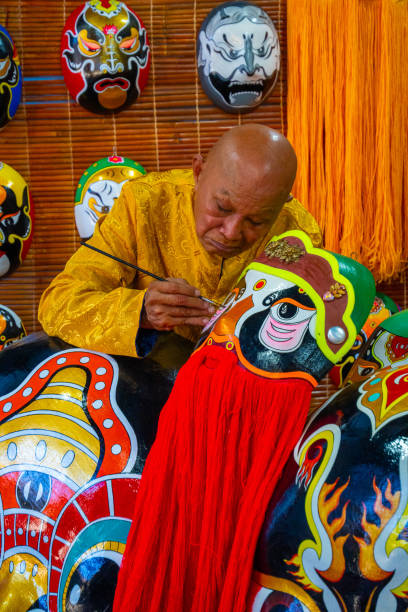 artisan making handmade antique masks in Hoi An ancient town, Quang Nam, Vietnam Quang Nam province, Vietnam - 13 Jul 2024: artisan making handmade antique masks in Hoi An ancient town, Quang Nam, Vietnam vietnamese old man portrait stock pictures, royalty-free photos & images