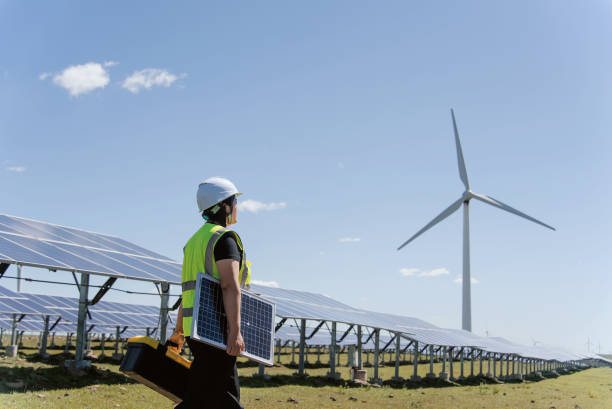 istock female technician working in solar power station 2165401327