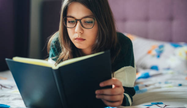 Girl reading a book at home