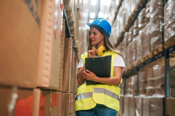 istock female Warehouse Worker with Clipboard 2165406855