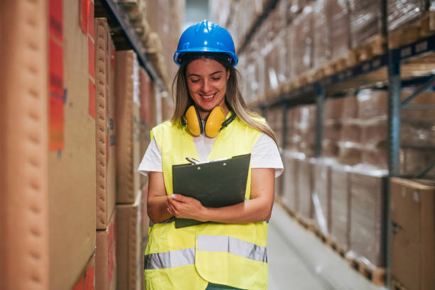 istock female Warehouse Worker with Clipboard 2165406995