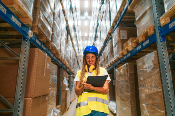 istock female Warehouse Worker with Clipboard 2165407256