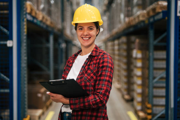 istock female Warehouse Worker with Clipboard 2165408385