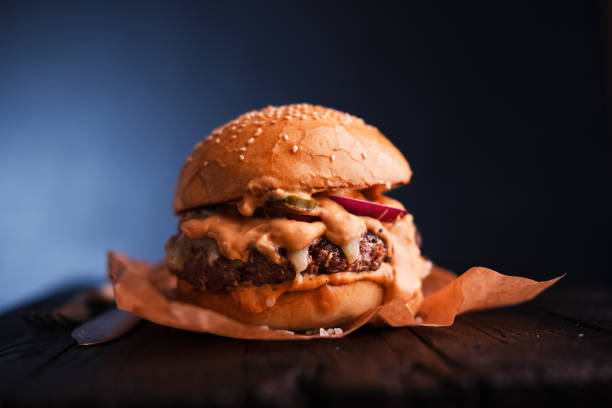 istock Appetizing sloppy cheeseburger on parchment paper 2165408847
