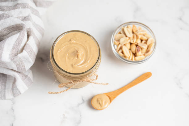 istock peanut butter, nut butter in a jar, peanuts, healthy eating 2165409053