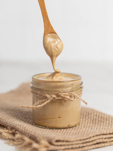 istock peanut butter, nut butter in a jar, peanuts, healthy eating 2165409070