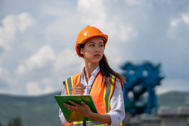 istock Survey team is working with a theodolite and road construction plans. Civil engineers are taking measurements with surveying tools during the construction. 2165410826