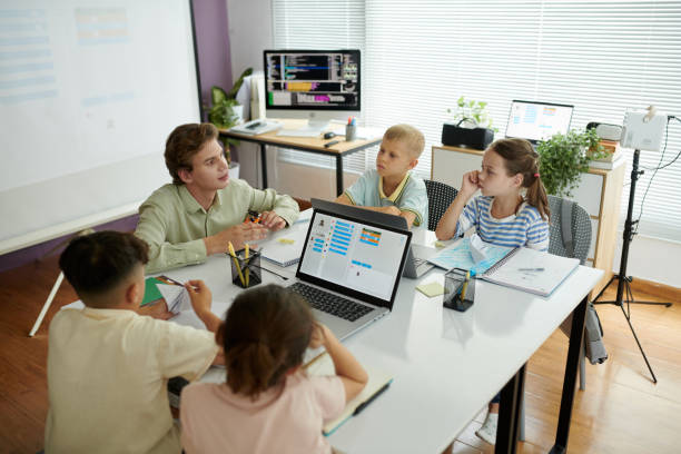 istock Teaching Group of Children in Modern Classroom Setting 2165410863
