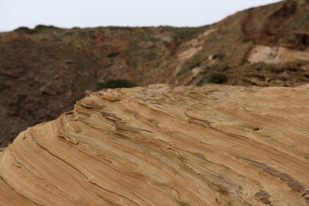Close-up of intricate sandstone swirls and erosion patterns, highlighting the natural beauty and texture of sedimentary rock formations. Perfect for geological themes and backgrounds.