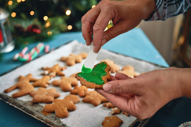 istock Decorating Gingerbread Christmas Cookies with Icing 2165413559