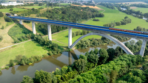 istock Railway bridge over river - aerial view 2165415717
