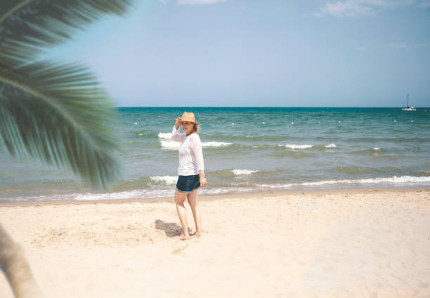 Happy Woman walking at the Caribbean sea beach. Copy space