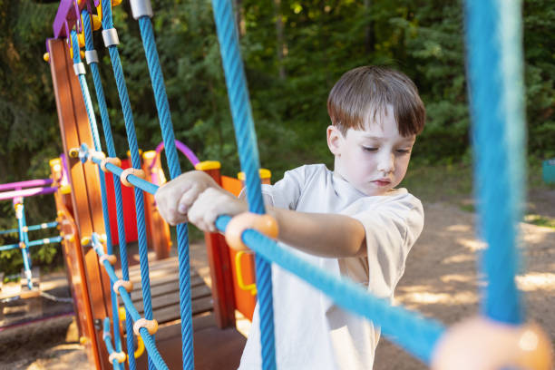 6 year old boy playing on a children's playground