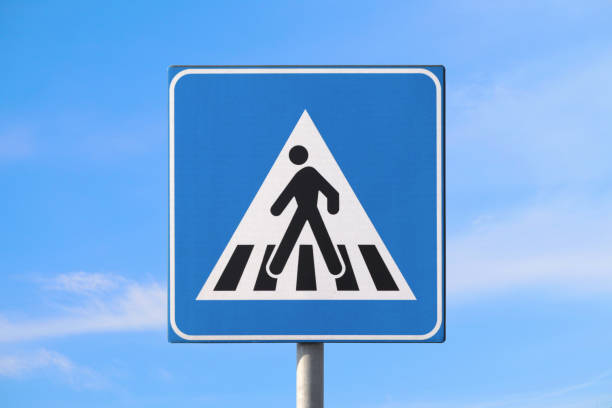 Pedestrian crossing road sign isolated in the sky