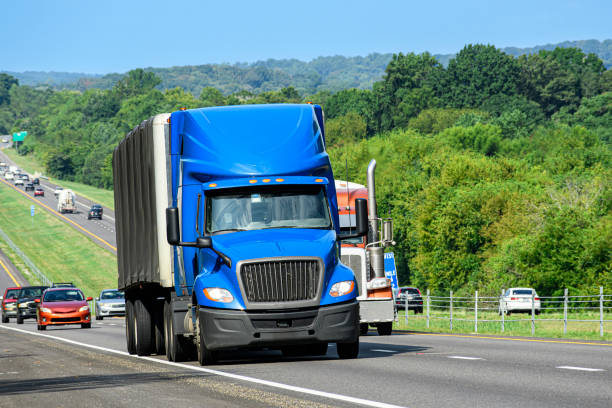istock Blue Eighteen-Wheeler Leads Traffic On The Interstate 2165419318