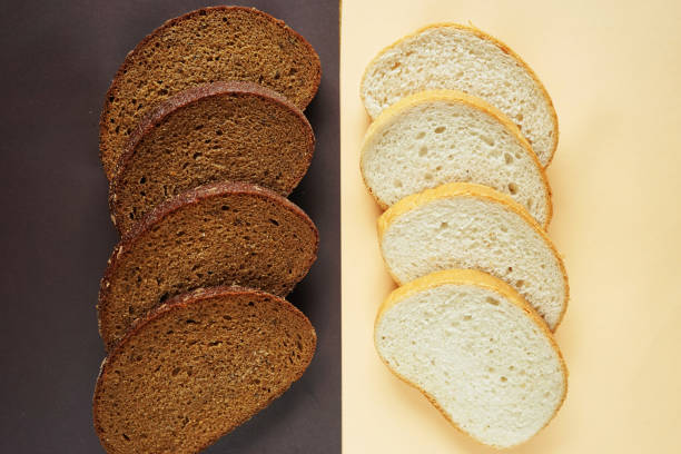 Rye and wheat pieces of bread on a beige-brown background