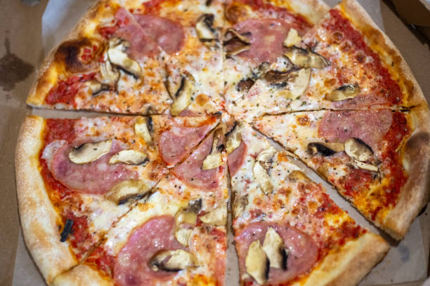 istock Fresh hot pizza in a box, cut into pieces. Order for fast delivery 2165421665