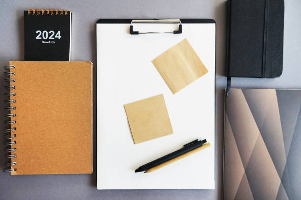 istock Workplace with paper holder, notepads, sticky notes, pens, glasses and calendar 2165422539