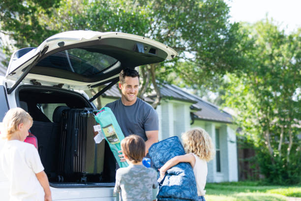 istock Children bring items for dad to load in SUV 2165423560