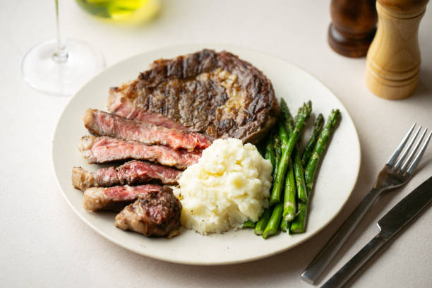 istock ribeye steak with asparagus and mushed potato 2165423844
