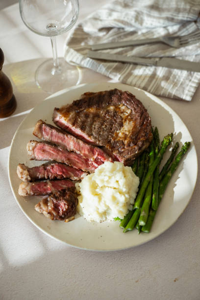 istock ribeye steak with asparagus and mushed potato 2165423895