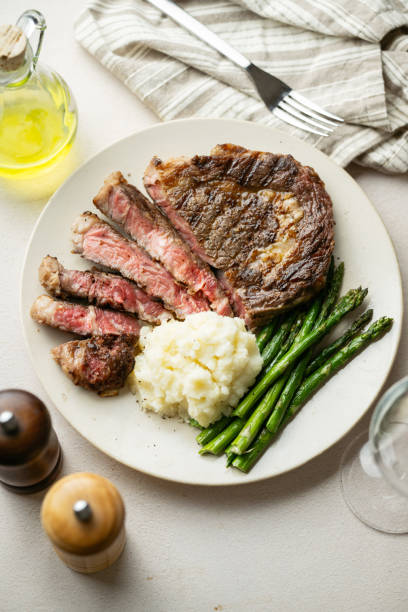 istock ribeye steak with asparagus and mushed potato 2165423921