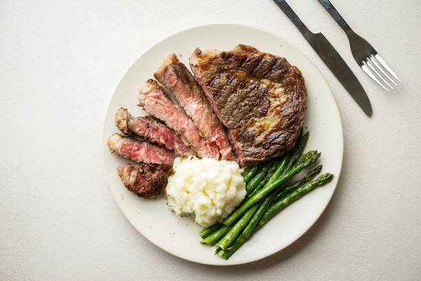 istock ribeye steak with asparagus and mushed potato 2165423964