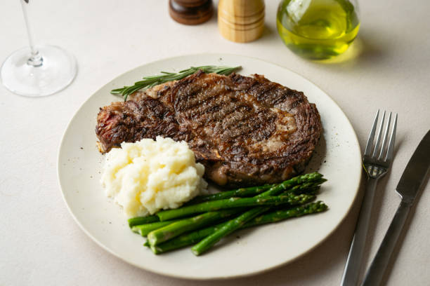 istock ribeye steak with asparagus and mushed potato 2165424035