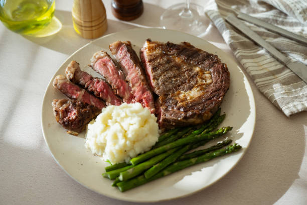 istock ribeye steak with asparagus and mushed potato 2165424095