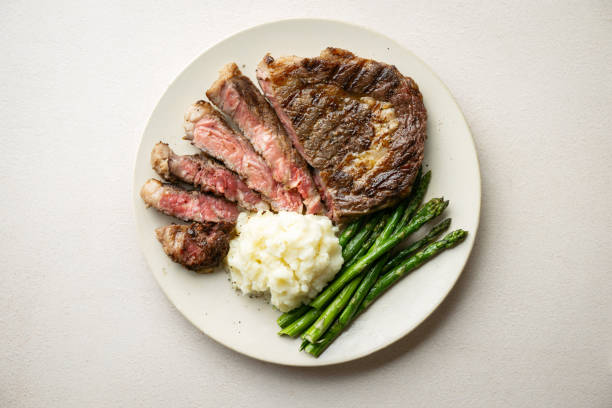 istock ribeye steak with asparagus and mushed potato 2165424231
