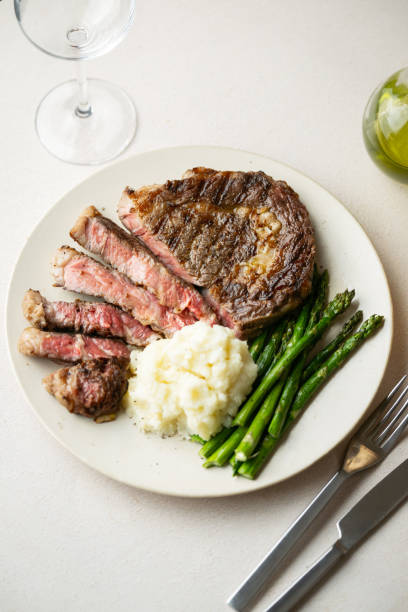 istock ribeye steak with asparagus and mushed potato 2165424299
