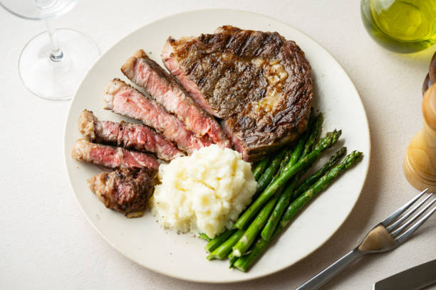 istock ribeye steak with asparagus and mushed potato 2165424330