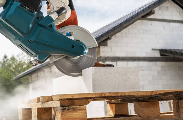 istock Cutting Concrete Blocks With Power Tool at Construction Site in Bright Daylight 2165425716