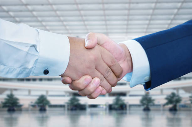 istock Business handshake on bright background, Two businessman shake hand with partner to celebration partnership and business deal concept. 2165434057