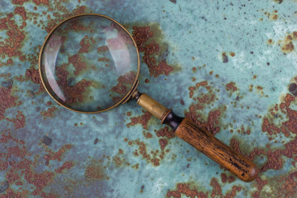 istock magnifying glass on metal rusty background, 2165435978