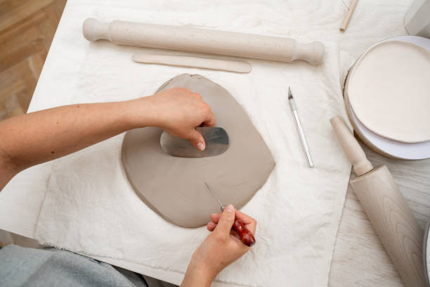 istock Wedging the clay to eliminate air bubbles. Creating perfect homogenous consistence for ceramics handcraft. 2165436508