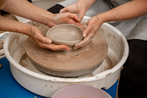 istock Ceramics workshop. Modeling a shape of your own clay project. Improving skills in traditional pottery. Learning how to create a bowl using a pottery wheel. 2165436712