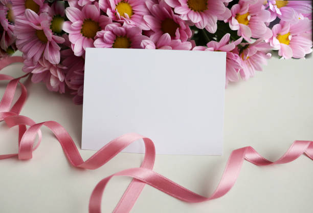 A bouquet of pale pink roses with fresh green leaves, set with a blank round card in the center, on a vibrant magenta background, perfect for celebration greeting card designs.