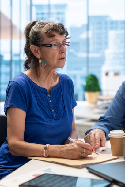 istock Elderly people in a modern office setting meeting with financial advisor 2165438255