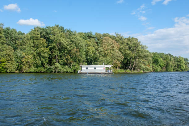 House Boat on the Lake House boat anchored on a summer lake in Berlin, Germany. small houseboats stock pictures, royalty-free photos & images