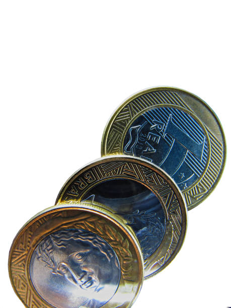 istock Brazilian coins worth one Real, lined up on a white background. 2165438820