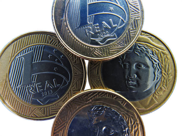 istock Four Brazilian coins worth one Real, arranged on a white background. 2165439022