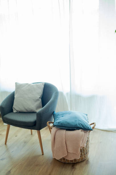 istock Home cozy interior, pink knitted plaid, jute basket. 2165439131