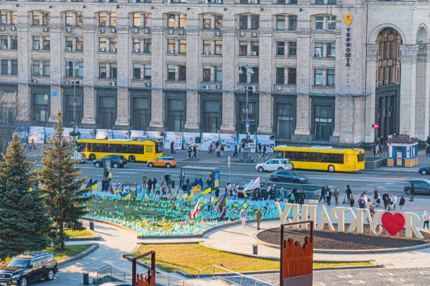 Busses on Evening view of the Independence Square background with monuments, Stella, Institutskaya Street, an exhibition of photographs ATO, Stalin and modern architecture KIEV, UKRAINE 05-04-2024.