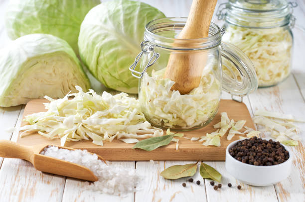 istock Pickling cabbage at home on table. Prepare homemade sauerkraut or fermented cabbage. 2165445908