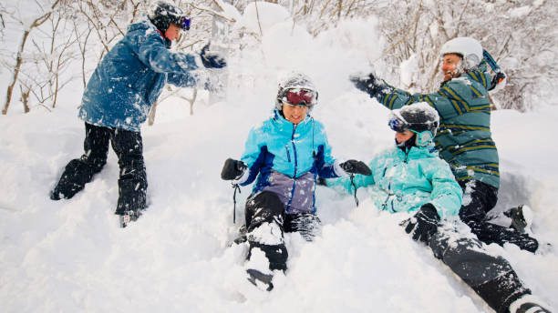 Two Parents Playing in the Snow with their Children