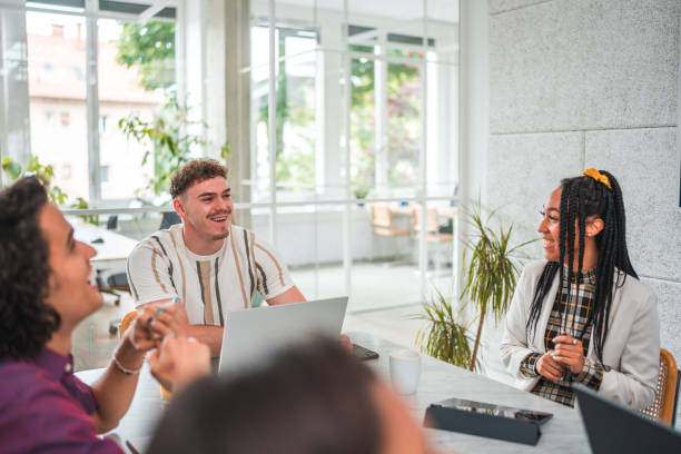istock Enthusiastic Diverse Gen Z Professionals at Boardroom Meet 2165450242