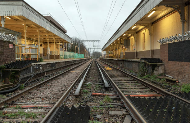 istock Perspective view on empty railway tracks and electric infrastructure equipment, wires at Acton central rail station. 2165450406